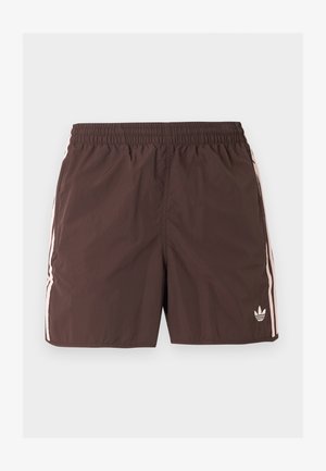 Hnedé športové šortky s elastickým pásom, svetloružovými bočnými pruhmi a malým logom Adidas trefoil na dolnej ľavej nohe.