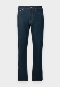Jean en denim droit bleu marine avec cinq poches et des coutures orange contrastantes sur fond uni.