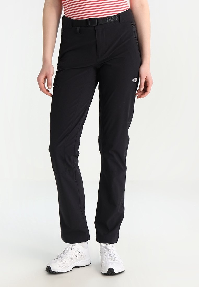 Black outdoor pants featuring a slim fit, belt loops, and side pockets. Made of lightweight, water-resistant material. Accented with logo detail.