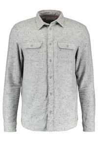 Šedá, dlouhá košile s dlouhým rukávem vyrobená z tečkované tkaniny. Obsahuje dvě náprsní kapsy, zapínání na knoflíky a špičatý límec. Měkká textura.