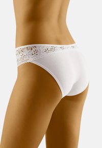 White cotton panties with a decorative lace waistband. The design features smooth texture, and a fitted shape, highlighting simplicity and comfort.