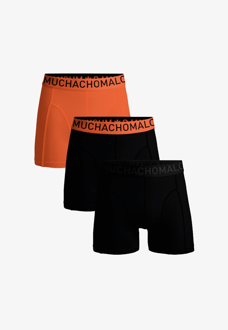 Trois paires de boxers pour hommes : une orange et deux noires. Chacune possède une ceinture noire avec la répétition du texte "MUCHACHOMALO". Tissu lisse.