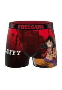 Boxers rouges mettant en avant une illustration d'un personnage avec des cheveux noirs, une veste rouge et un pantalon jaune, avec le logo "FREEGUN" sur la ceinture.