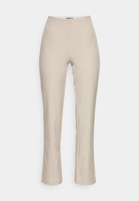 Pantalons beiges ajustés avec une texture lisse, taille haute et bas évasé. Présente des plis à l'avant pour plus de forme. Pas de poches visibles.