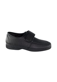 Zapato negro con tira de velcro, textura suave, punta redonda y suela de goma baja. Diseño minimalista adecuado para uso casual.