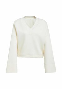 Kort, vit sweatshirt med V-ringning och oversize ärmar. Har en subtil präglad logotyp på bröstet i matchande färg. Slät textur.