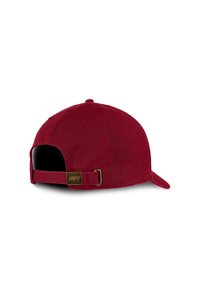 Red cotton baseball cap with a curved brim, adjustable strap at the back, and a gold metal logo tag. Textured fabric and solid color.