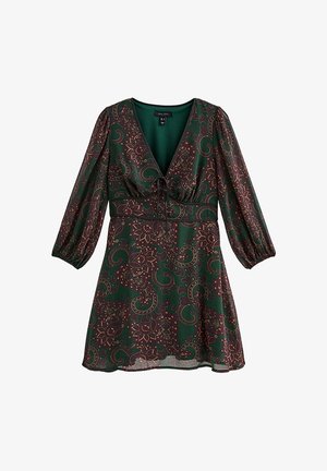 Groene jurk met een paisley-patroon in paars en goud. Heeft een V-hals, elastische tailleband en pofmouwen. Lichtgewicht stof.