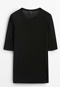 T-shirt noir à manches courtes en tissu texturé, avec un col rond et une coupe ample, conçu pour un usage décontracté.