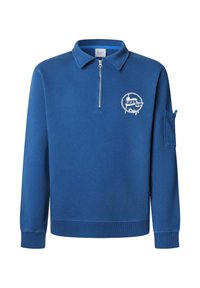 Mėlynas megztinis su ketvirčio užtrauktuku, raukšlėtais rankogaliais ir logotipu ant krūtinės. Pagamintas iš minkštos, tekstūruotos medžiagos.