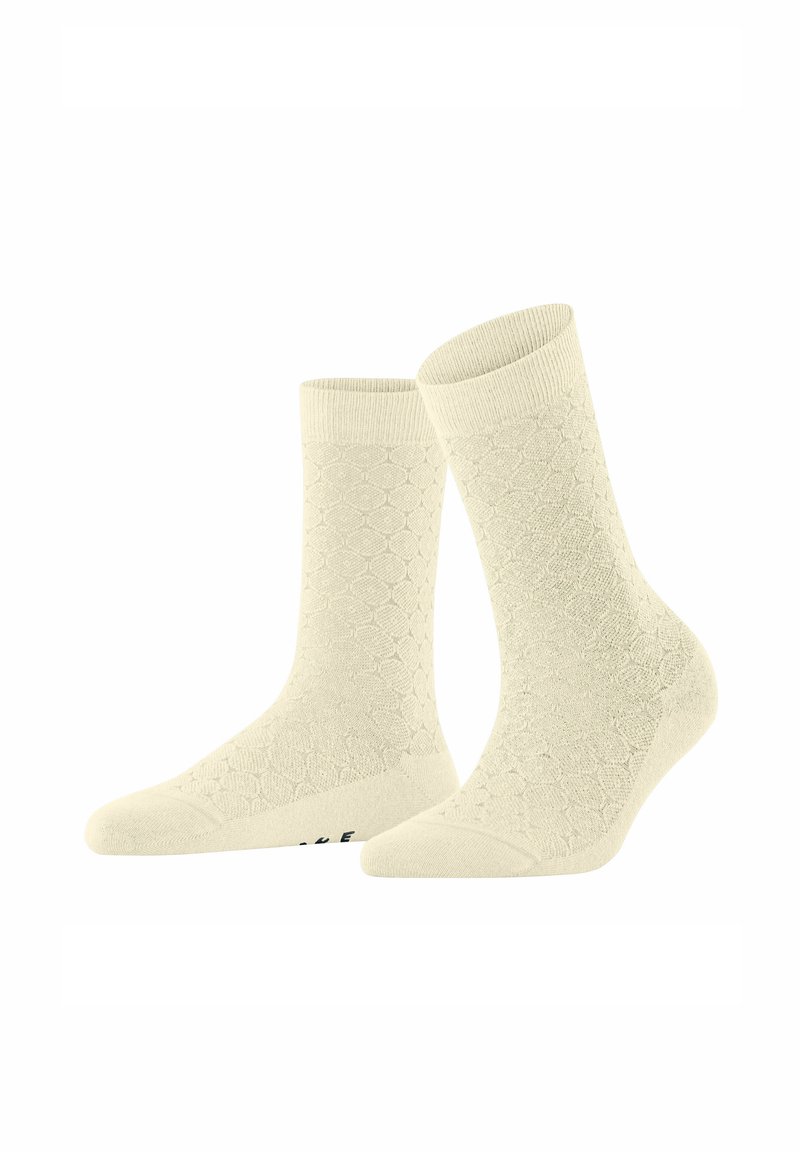 Beige Socken mit einem strukturierten, Wabenmuster. Gerippte Öffnungen und verstärkte Zehenkappen. Weicher Stoff, knöchelhoch.