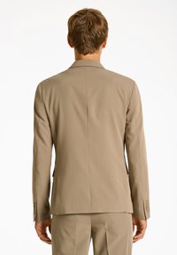 Beige Herrenjacke mit strukturierten Schultern und glatter Textur. Verfügt über einen Schlitz auf der Rückseite und Manschetten mit drei Knöpfen.