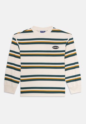 Ilgų rankovių medvilninė marškinė su kreminiu pagrindu, puoštos horizontaliomis juostelėmis tamsiai žalia, garstyčių geltona ir šviesiai mėlyna spalvomis. Su logotipo ašara.