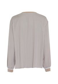 Light gray long-sleeve blouse with a relaxed fit, featuring ribbed cuffs with horizontal stripes in cream and tan. Smooth fabric texture.