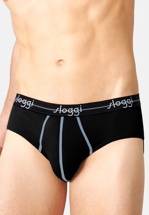 Schwarze Baumwollslips mit einem Logo-Bund in hellblauen Akzenten und vertikalen Steppnähten. Weicher Stoff mit einer enganliegenden Passform.