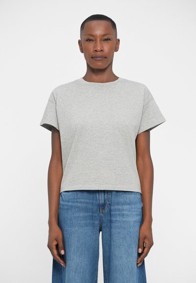 Gray, short-sleeve T-shirt with a round neck, featuring a relaxed fit and smooth texture, paired with high-waisted blue denim wide-leg pants.
