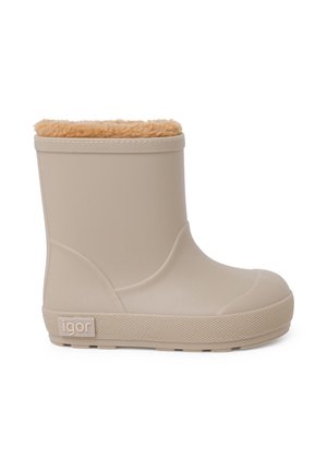 Botte courte en caoutchouc beige avec semelle texturée et doublure douce en fourrure couleur fauve visible sur le bord supérieur, vue de côté.