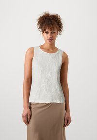Top sin mangas de color gris claro con tejido texturizado, que presenta patrones florales y un escote redondo. Acabado suave en el dobladillo.