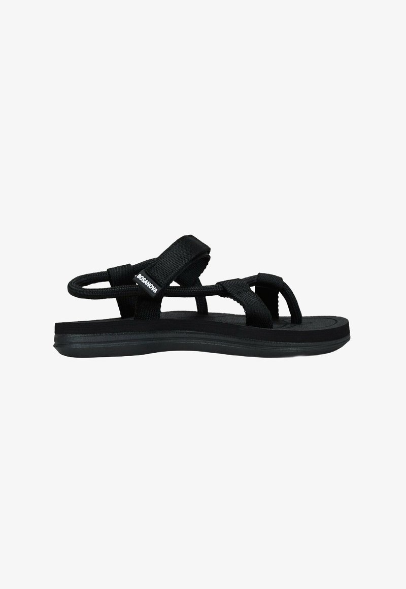 Black sandals with a textured rubber sole, featuring wide fabric straps for support and a minimalist design. Adjustable fit and open-toe style.