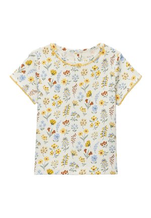 Chemise crème à manches courtes avec de petits motifs floraux multicolores en jaune, bleu et orange, comportant une bordure jaune festonnée sur les bords.