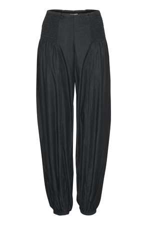 Pantalones negros de corte holgado con cintura elástica fruncida y puños elásticos recogidos, confeccionados en tela ligera y texturizada.