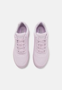Light purple Skechers sneakers with a smooth texture, perforated detailing on the sides, padded collar, and lace-up front design.