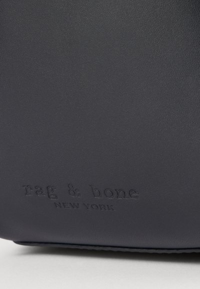 Navy leather bag featuring embossed "rag & bone NEW YORK" branding. Smooth texture with a structured shape and subtle sheen.