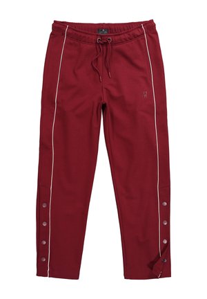 Viininpunaiset verkkarihousut valkoisilla sivuviivoilla, joustava vyötärönauha kiristysnyörillä, nappikiinnitys alareunassa ja hillitty logo reisiosassa.