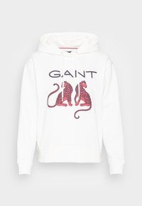 Sudadera blanca con un gráfico central de dos tigres rojos y rosas, con el texto "GANT" arriba en fuente negrita negra. Capucha con cordón.