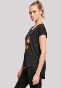 Black cotton T-shirt with short rolled sleeves, featuring a colorful cartoon graphic and text on the front, relaxed fit, and curved hem.