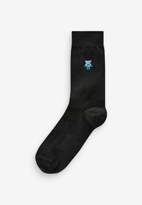 Black cotton sock featuring a small blue embroidered monster design on the side, with a smooth texture and standard crew length.