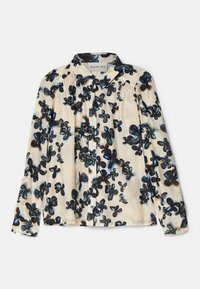 Blouse crème à manches longues avec imprimé floral abstrait noir et bleu, boutonnée sur le devant, avec des fronces près des épaules.