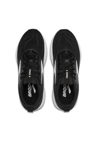 Chaussures de sport noires avec une tige en mesh texturé, accents blancs, lacets plats et une semelle rembourrée pour le soutien. Marquages "Brooks" et "Trace 4" visibles.