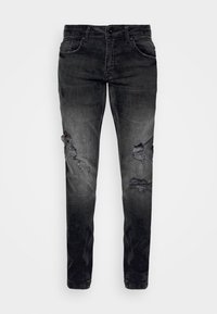 Jeans de mezclilla negra con un diseño desgastado, que presenta detalles rasgados y una apariencia descolorida. Corte ajustado con bolsillos estándar y cierre de botón.