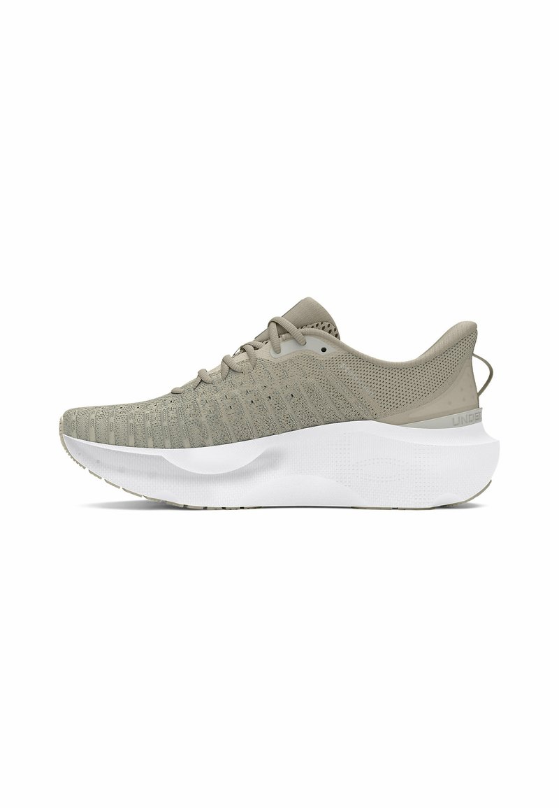 Beige athletic shoes with a knitted mesh upper, textured design, and a thick white midsole. Features a pull tab at the heel.