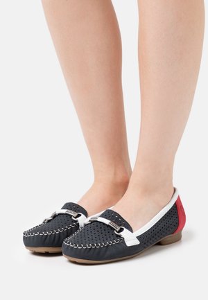 Marineblaue Slipper mit Lochmuster, weißen Akzenten und rotem Absatz. Verfügt über einen dekorativen Riemen mit Metallbeschlägen und kontrastierenden Nähten.