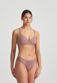 Mauve lingerie set featuring a smooth, seamless bra with adjustable straps and matching low-rise panties with sheer accents and a minimalist design.