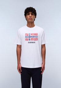 White cotton t-shirt featuring a colorful design of the Norwegian flag with wavy patterns, and text "NAPAPIJRI" below the flag.