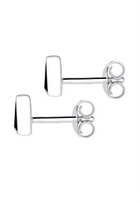 Silverfärgade stiftörhängen med geometrisk design, som har en polerad yta och cirkulära bakstoppningar. Minimalistisk och symmetrisk form.