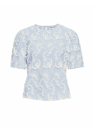 Helebeež särgiga lühikeste varrukatega, millel on valge lilleline tikand, ümmargune kaelus ja kergelt kogutud külgedel. Pehme kangas koos tekstuursete detailidega.