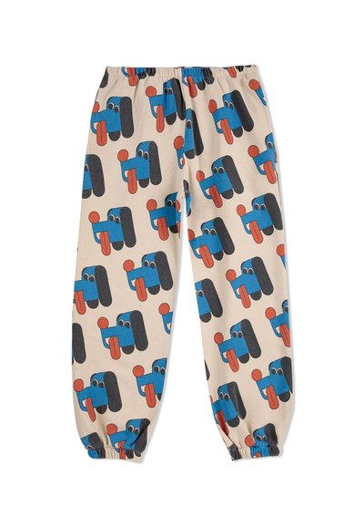 Baumwollhose mit einem elastischen Bund, auf einem beigen Hintergrund mit einem verspielten Muster aus blauen und schwarzen Comic-Gesichtern mit roten Akzenten.