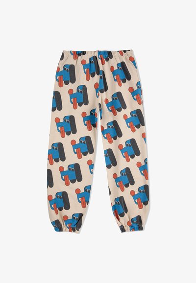 Bavlnené nohavice s elastickým pásom, s béžovým pozadím a hravým vzorom modrých a čiernych rozprávkových tvárí s červenými akcentmi.