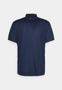 Námořnická modrá polo košile, krátké rukávy, měkká tkanina, klasický límec, hladká textura, minimální detaily na zadní straně, klasický střih.
