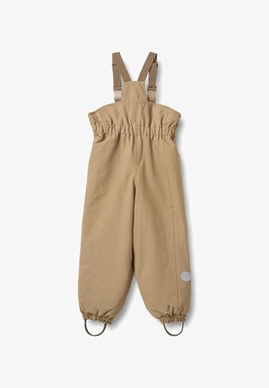 Salopetă bej impermeabilă cu bretele reglabile, talie elastică și glezne strânse. Are un logo circular pe piciorul stâng.