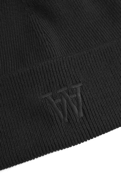 Bonnet en tricot noir avec une texture côtelée, présentant un design de logo en relief et en relief sur le bord. Matériau doux et flexible pour le confort.