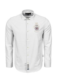 Bílá košile s dlouhým rukávem, zapínáním na knoflíky a límečkem, na hrudi s potiskem královského loga a dekorativním prošíváním na spodním lemu.