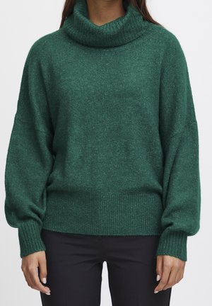 Green, oversized turtleneck sweater with a soft texture, ribbed cuffs, and hem. Features a relaxed fit and moderate length.