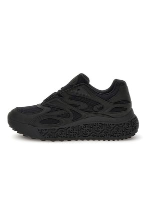 Black athletic shoe with a textured mesh upper and rubber sole featuring a distinctive patterned tread design. No visible branding.