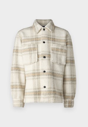 Fleece geruite jas in crème met grijze en gele strepen. Voorzien van een kraag, twee borstzakken en zwarte knopen. Zachte textuur.