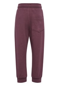 Bordeaux joggings met een rekbare tailleband, ribbelmanchetten en één achterzak. Glad textuur, strakke pasvorm en enkellang.